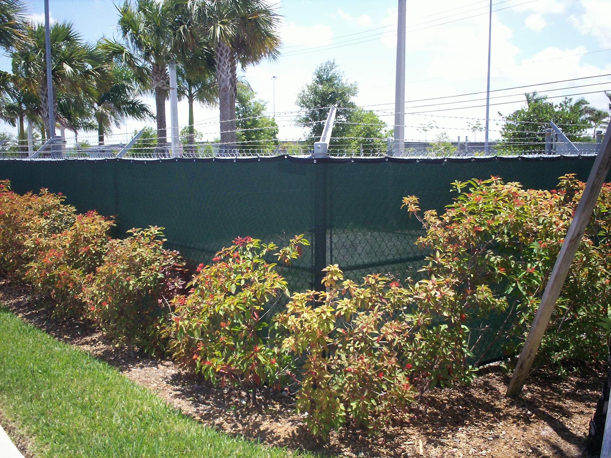 Exterior screening installed along building and walkway