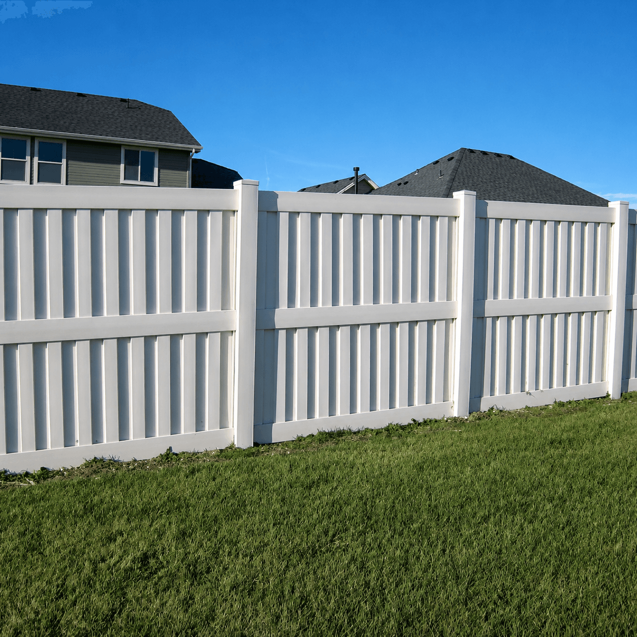 White vinyl shadowbox privacy fence panels at a residential property
