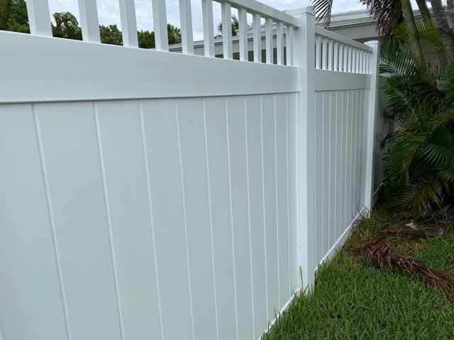 Residential perimeter fence beside garden and exterior wall