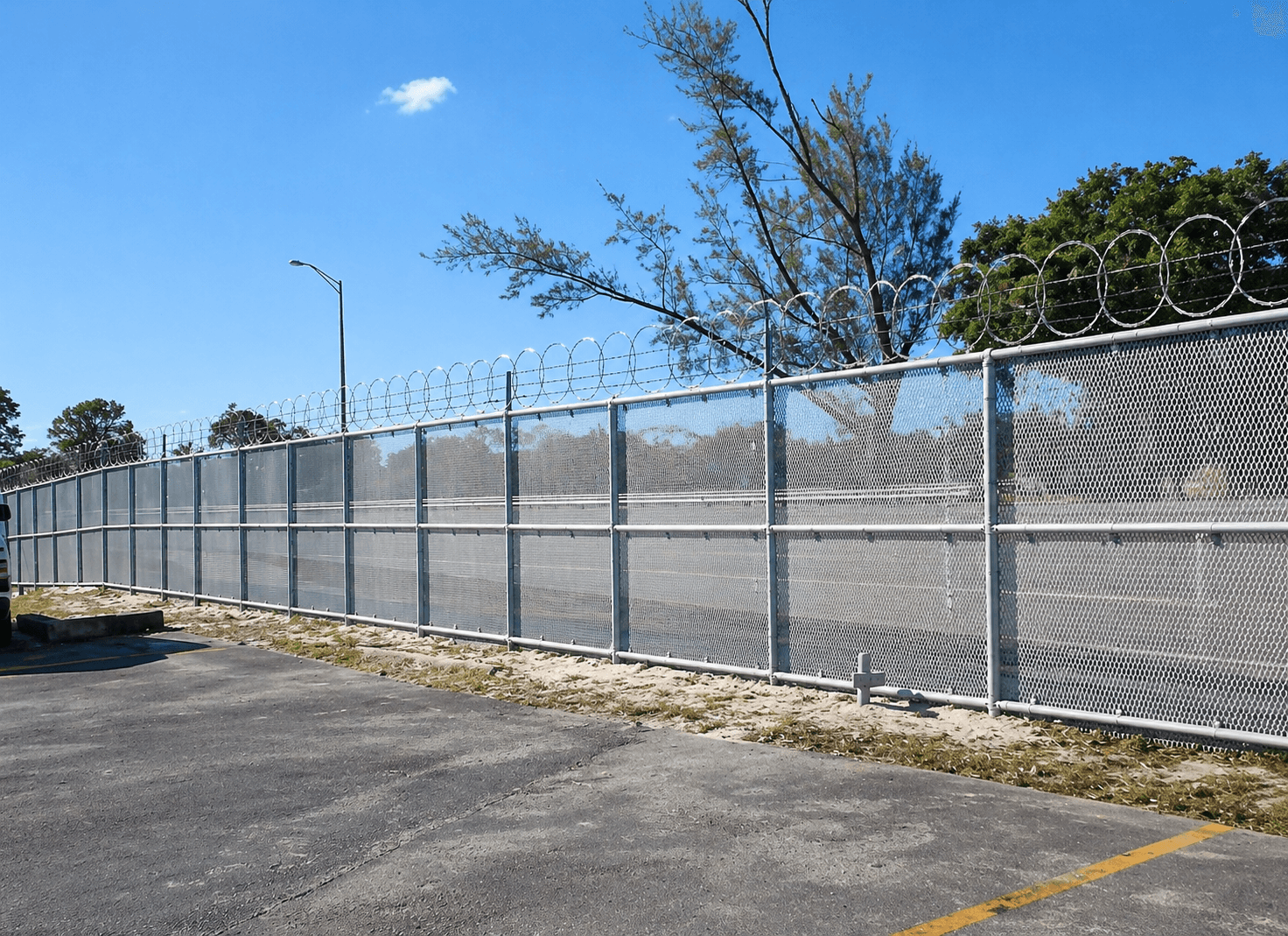 Industrial slide security gate across chain link entrance with keypad access