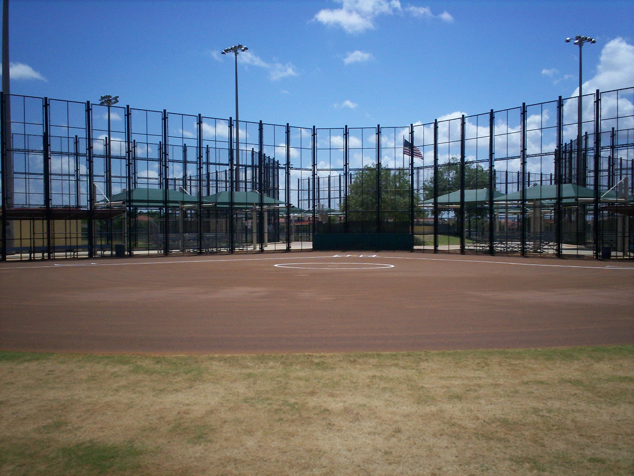 Athletic facility chain link backstop fencing along the field perimeter